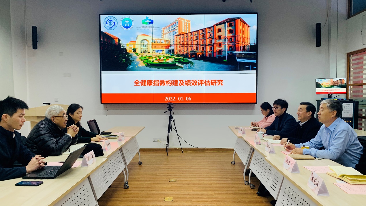 A group of people sitting in a room with a projector screenDescription automatically generated with medium confidence